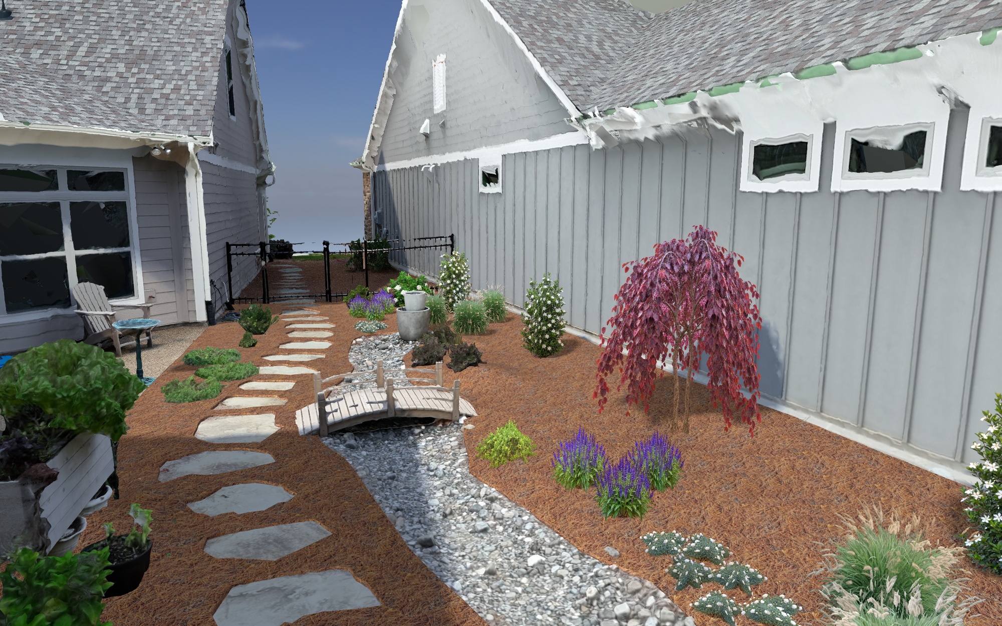 A view through the courtyard. The dry creek, bridge and stepping-stone path continue to connect the planting areas.